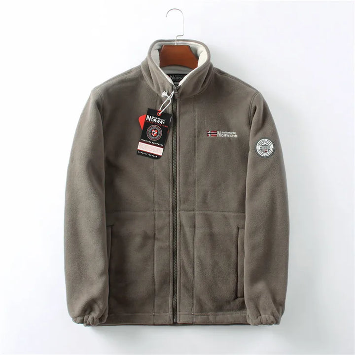 Modern men's blue full-zip winter jacket, stylish & warm outerwear for fashion-conscious men.