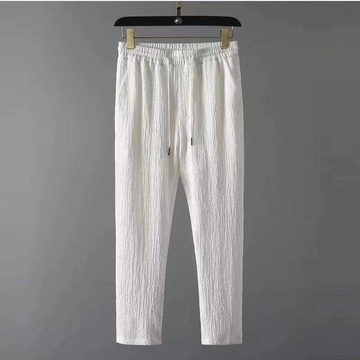 Stylish men's two-piece lounge set. V-neck top & drawstring pants for ultimate summer comfort.