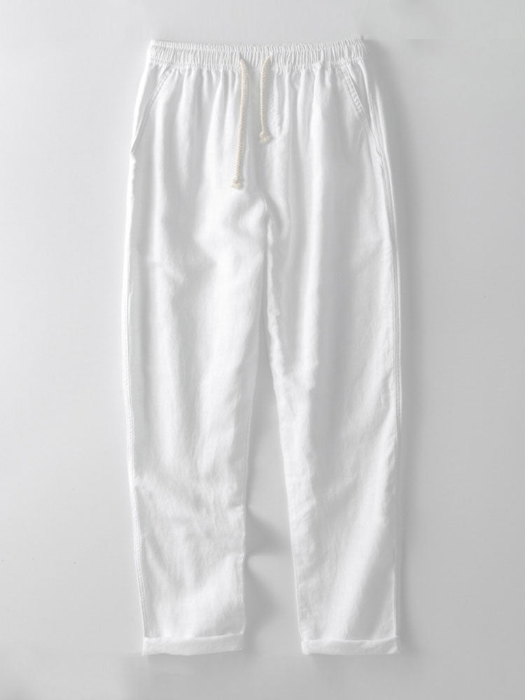 Men's linen short sleeve shirt with stand-up collar, paired with matching trousers for a relaxed look.
