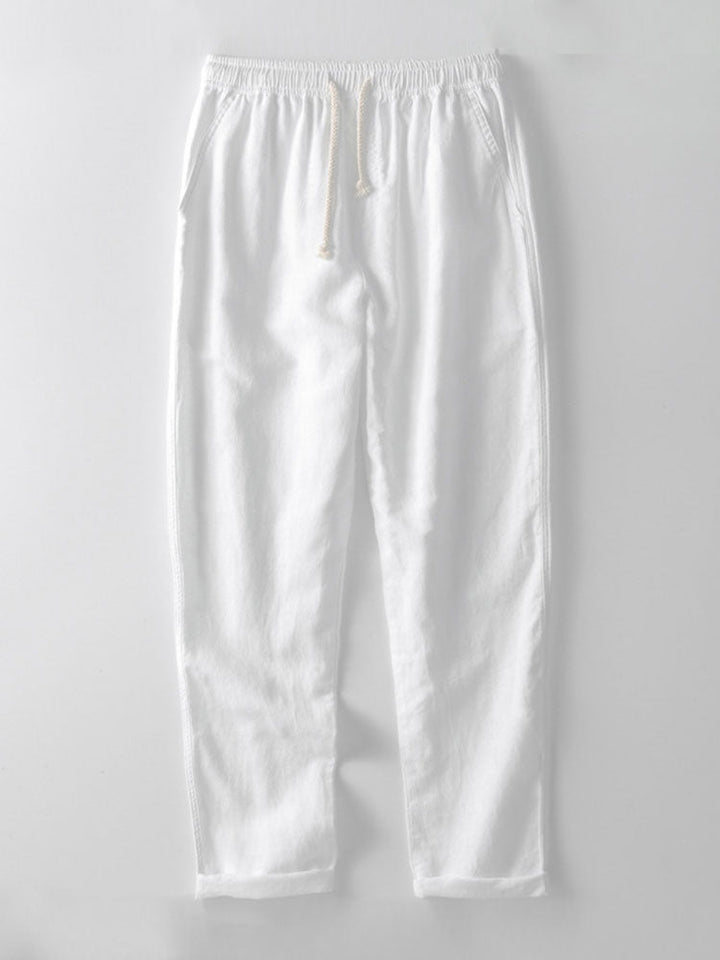Men's linen short sleeve shirt with stand-up collar, paired with matching trousers for a relaxed look.