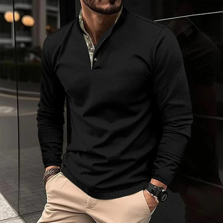 Close-up of a men's stylish long sleeve polo shirt, highlighting the colored collar and quality fabric.