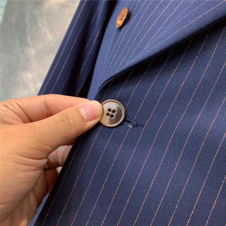 Double-breasted men's navy pinstripe suit. Tailored formal attire, ideal for business and professional events.