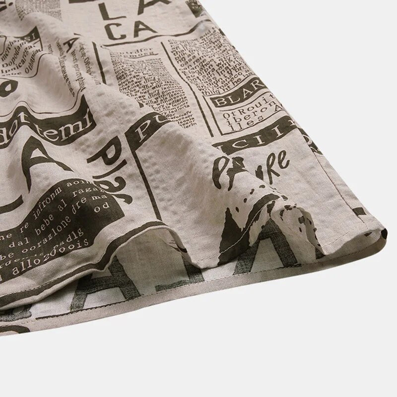 Close-up of the unique newspaper print on a men's stylish short-sleeve button-up shirt, a trendy top.