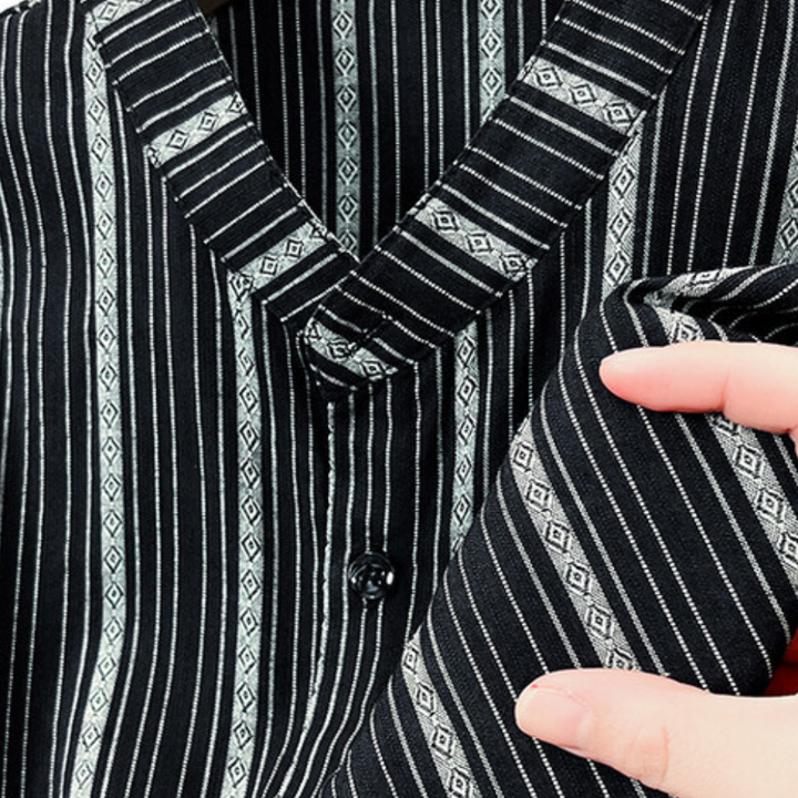 Man wearing a stylish striped summer shirt, perfect for a relaxed yet fashionable casual look.