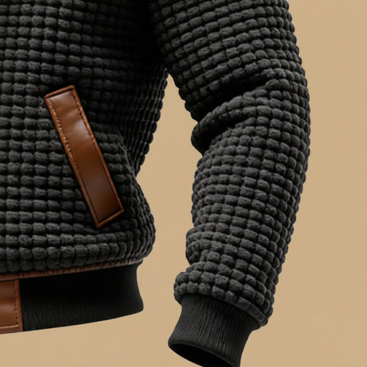 Man wearing a rugged textured winter jacket, keeping warm & stylish during outdoor activities in winter.