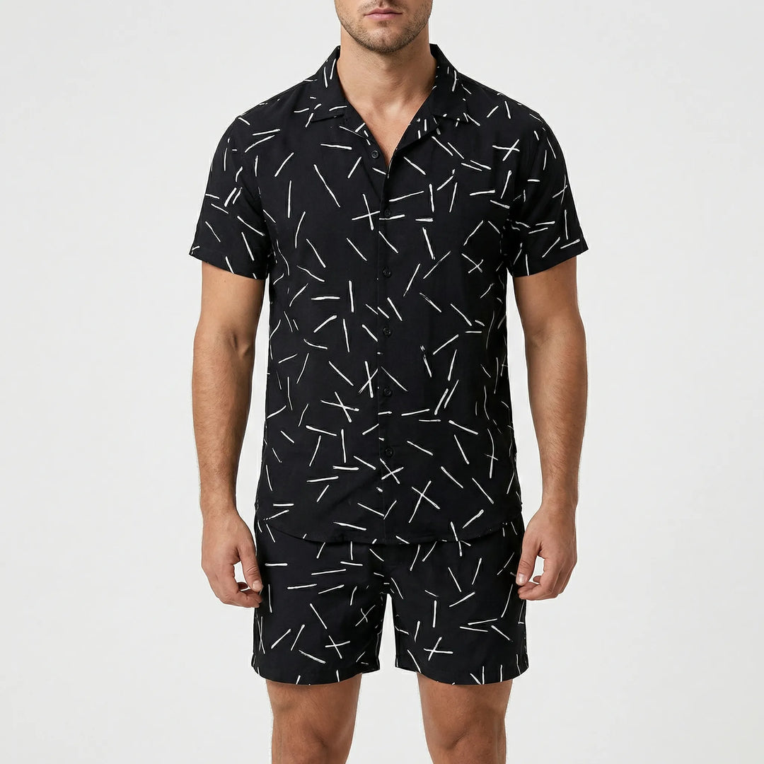 Model wearing the men's casual two-piece summer set with bold print, ready for a stylish vacation.