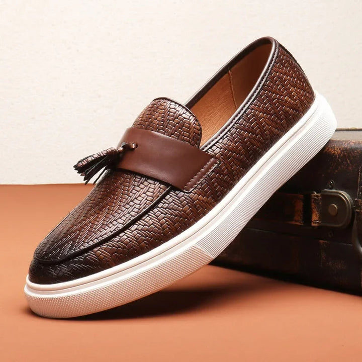 Men's stylish woven tassel loafers. Elegant slip-on shoes with intricate weave for refined casual or dress looks.