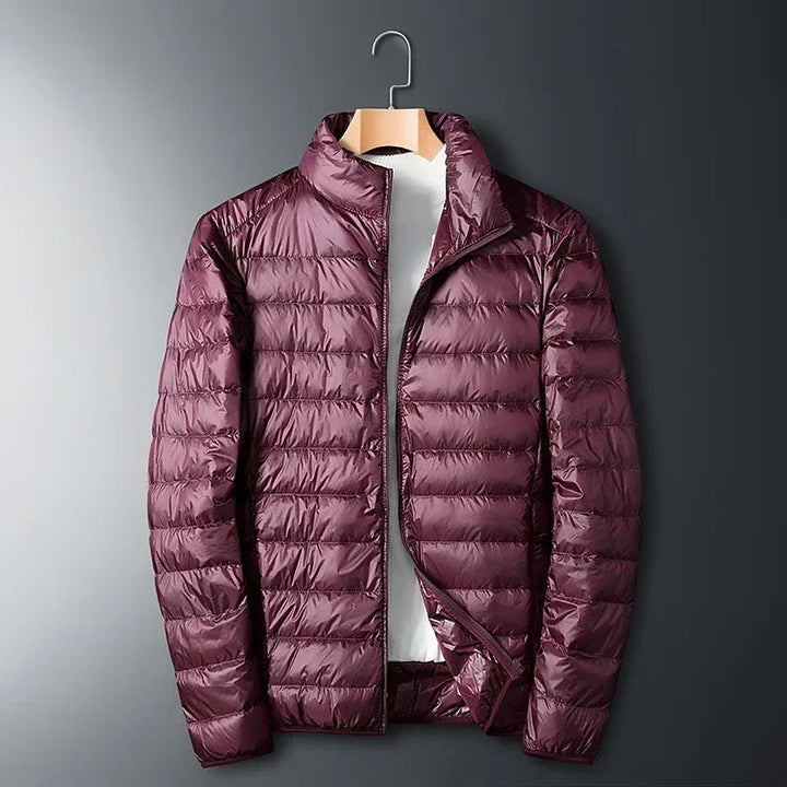 Gray men's Summit jacket, a premium thermal winter coat designed for extreme cold weather apparel.
