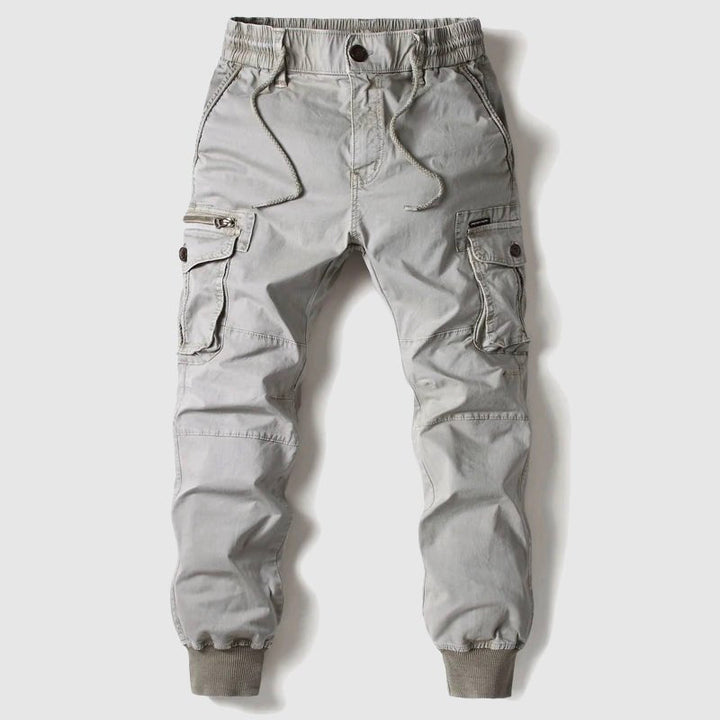 Rugged men's tactical pants with ample cargo pockets, ideal for outdoor activities & practical use.