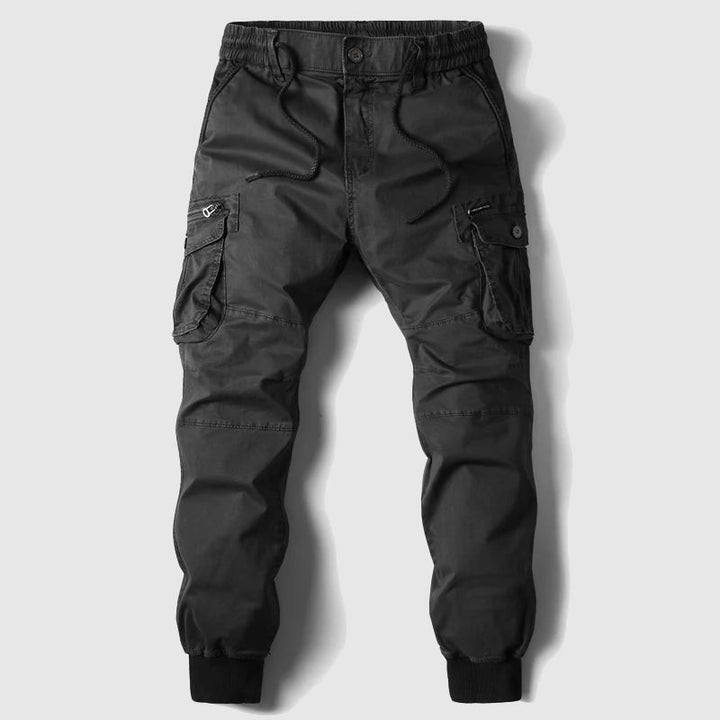 Men's multi-pocket cargo pants, blending tactical utility with a comfortable jogger fit for all seasons.