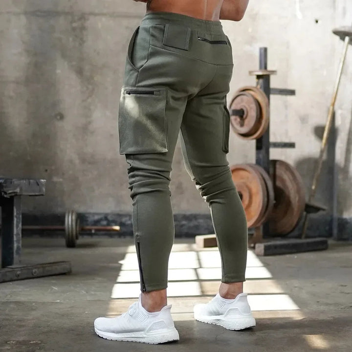 Men's training joggers, cargo pockets & tactical design. Tapered fit activewear.