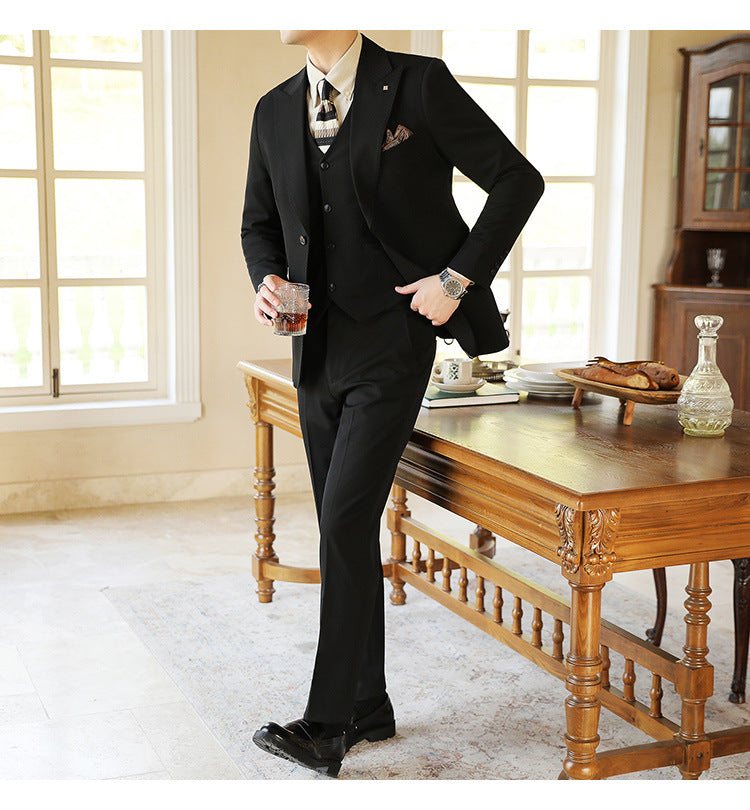 Detailed view of a men's three-piece suit lapel and vest, highlighting tailored formal wear quality.