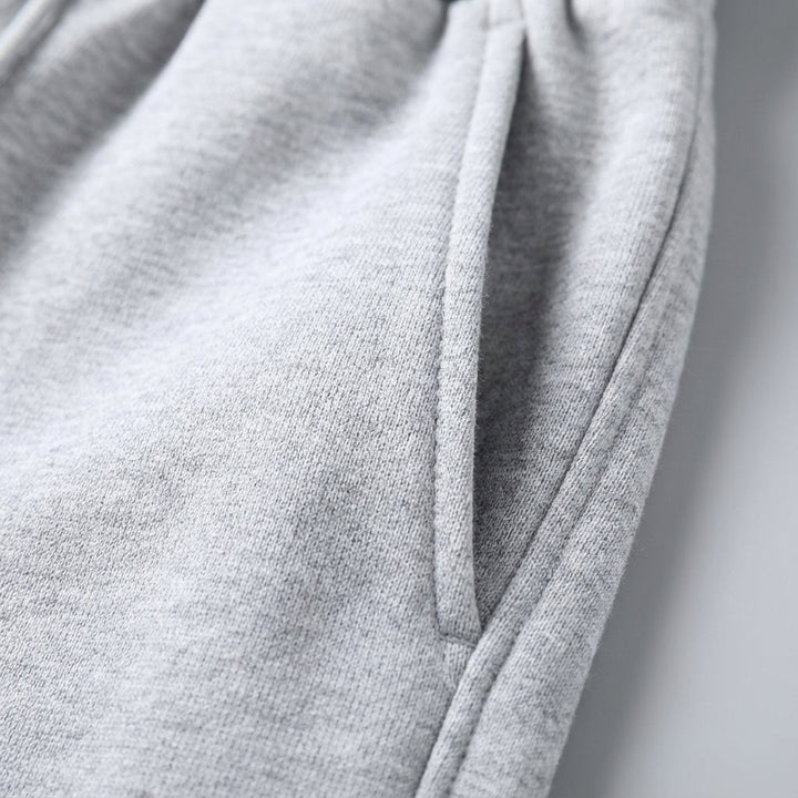 Men's black tapered jogger pants, showcasing a comfortable fit and modern style for casual or sport.