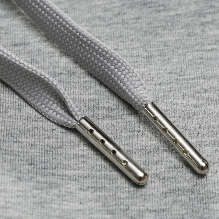 Detail of elastic waistband and drawstring on men's tapered jogger pants, offering adjustable comfort.