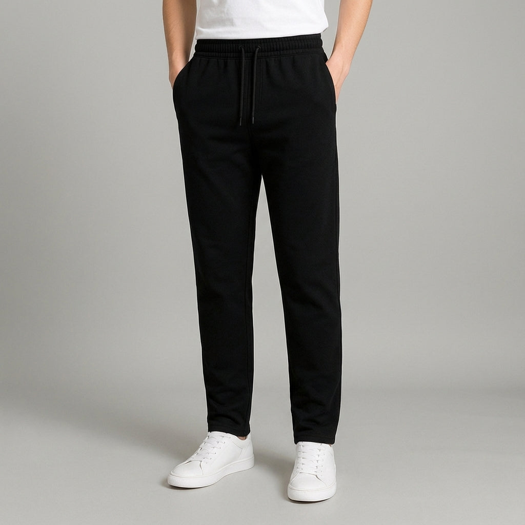 Model wearing men's tapered casual jogger pants with sneakers, demonstrating contemporary streetwear style.