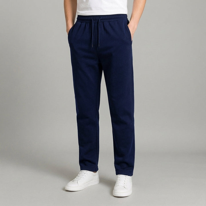 Back view of men's tapered jogger pants in a relaxed fit, highlighting pocket detail and athletic cut.