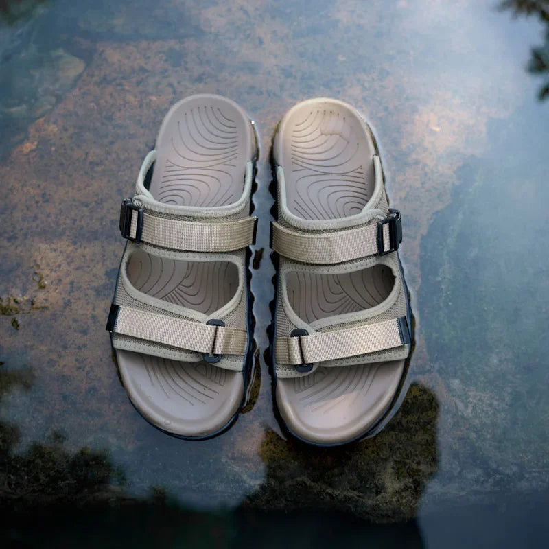Side view of khaki Men's TerraGlide adventure sandals, highlighting adjustable straps & durable sole.