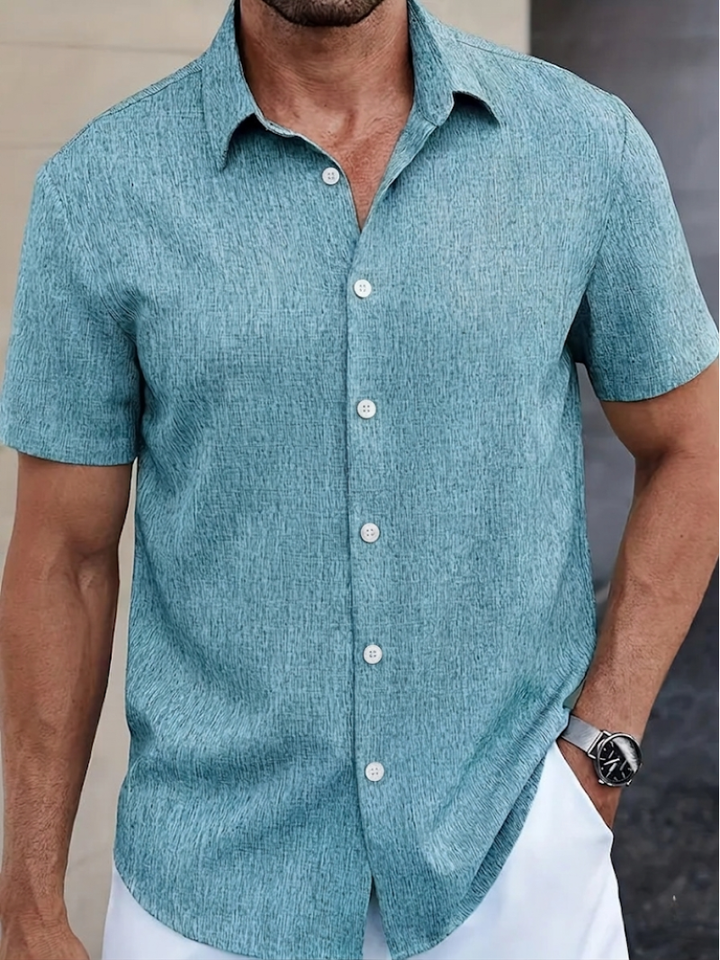 Classic men's regular fit polo shirt. Features button-down, short sleeves & subtle texture for versatile wear.