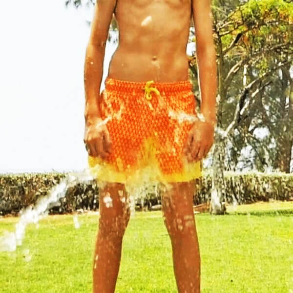 Thermal reactive men's swim shorts, changing from blue to orange with warmth, beach apparel