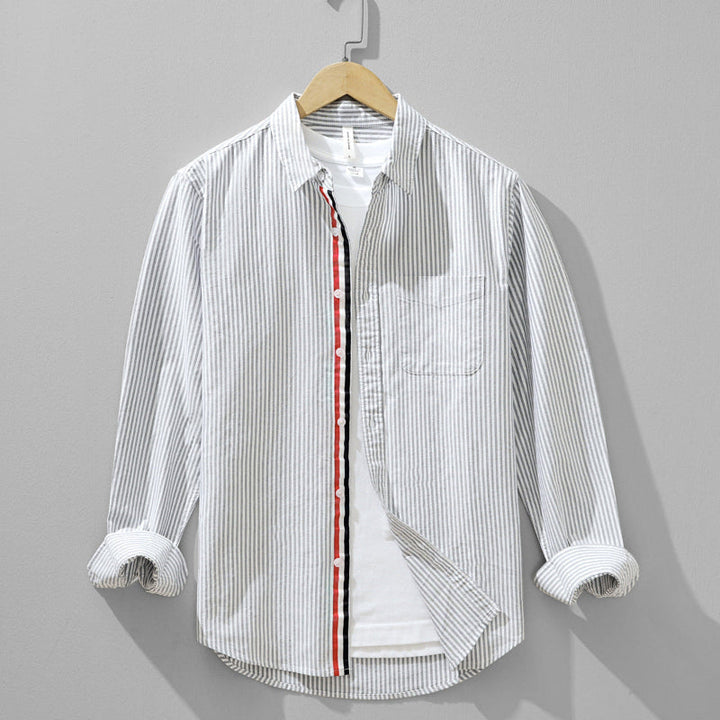 Versatile men's gray striped button-up shirt for smart casual or everyday wear. Classic long sleeve menswear top.