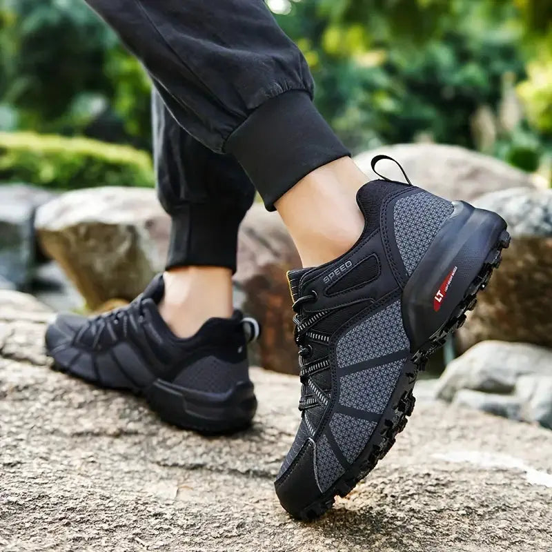 Men's TrailStep Pro breathable hiking shoes, black with blue accents, side view, forest trail background
