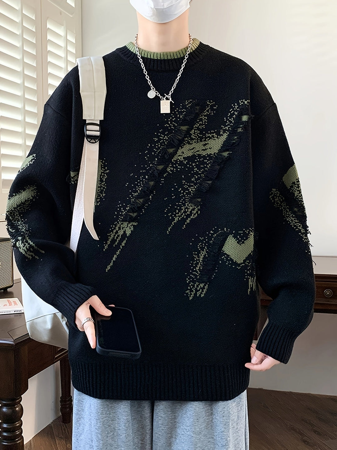 Men's trendy oversized knit sweater with stylish frayed details. Perfect for casual autumn & winter fashion.