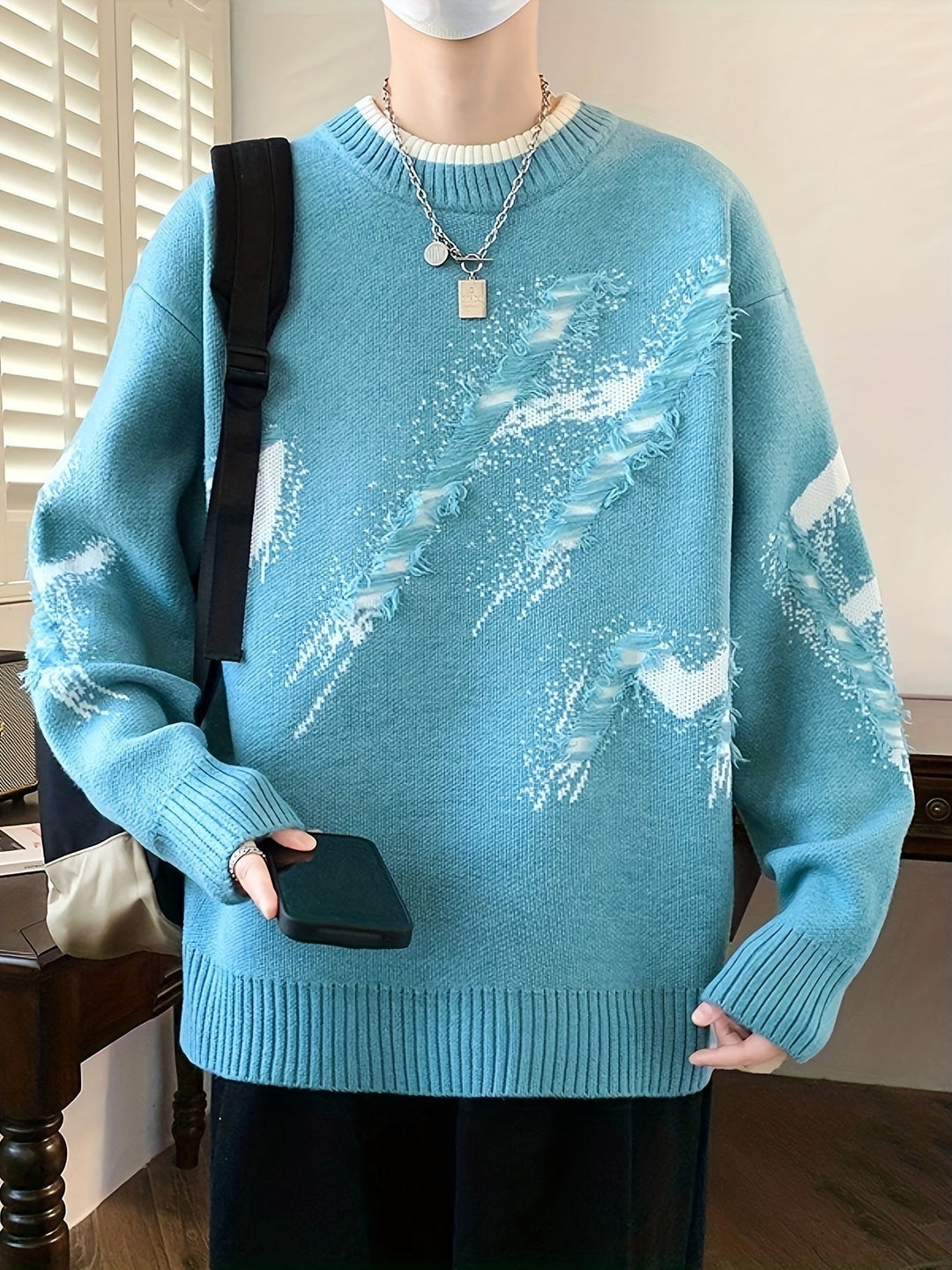 Casual men's oversized long-sleeve sweater, featuring trendy frayed edges & a relaxed fit for cool weather.