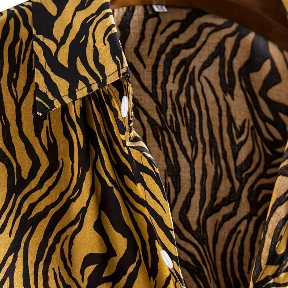 Bold men's tiger print button-up shirt. A trendy statement piece for modern men's casual fashion.