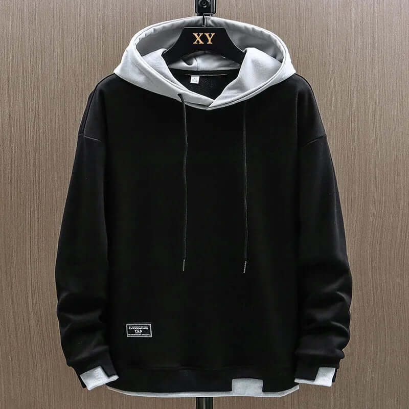 Relaxed fit men's colorblock hoodie in two-tone design, perfect for streetwear and casual comfort.
