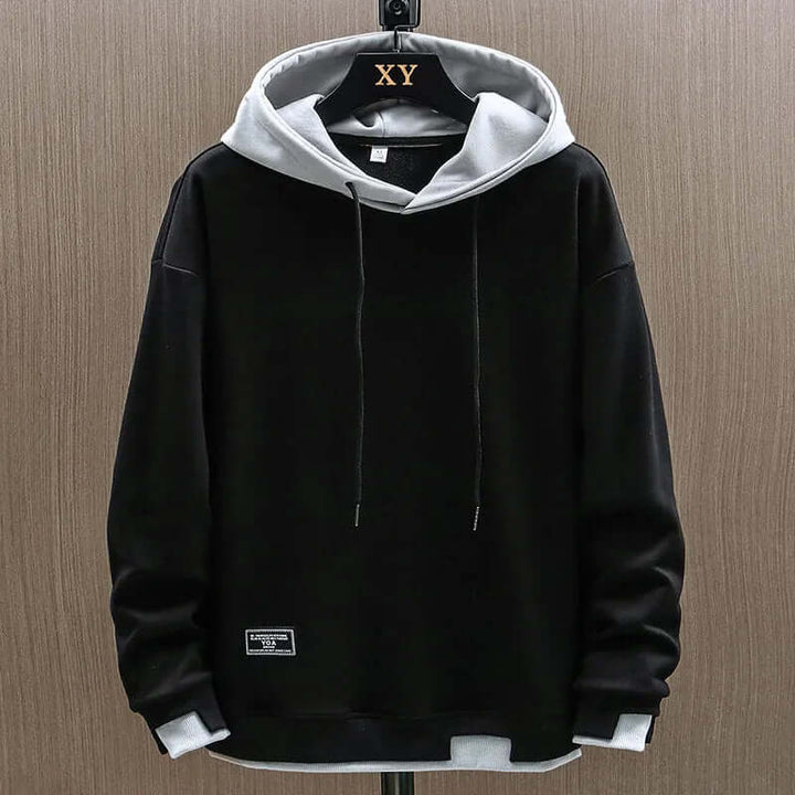 Relaxed fit men's colorblock hoodie in two-tone design, perfect for streetwear and casual comfort.