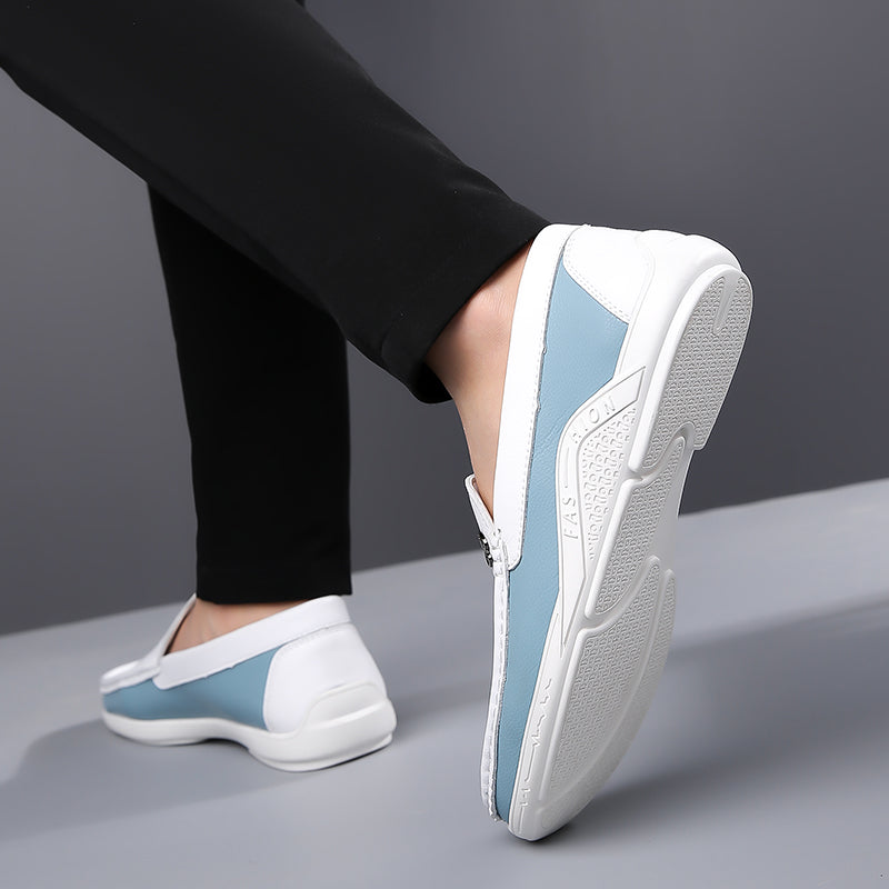 Side view of men's two-tone slip-on loafers, highlighting the elegant silhouette.