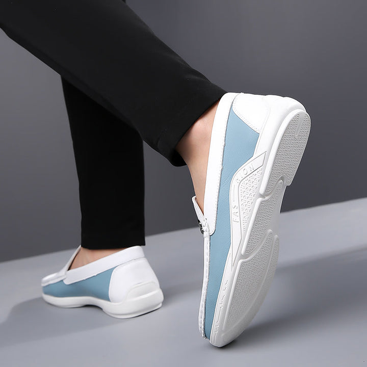 Side view of men's two-tone slip-on loafers, highlighting the elegant silhouette.