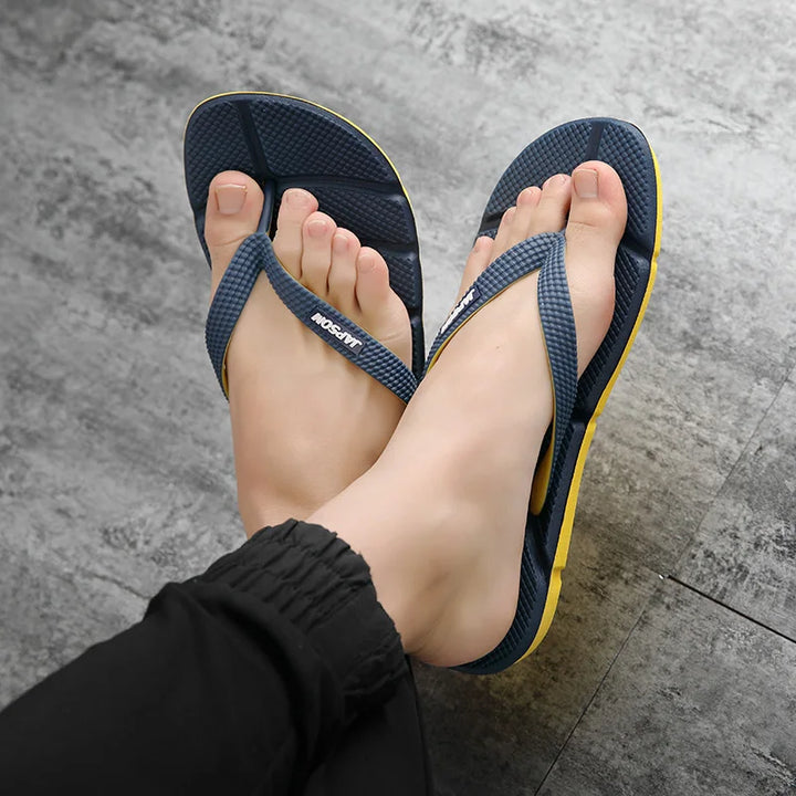 Side view of men's ultimate comfort flip flops. Durable, non-slip sole for massage & foot relief. Casual wear.