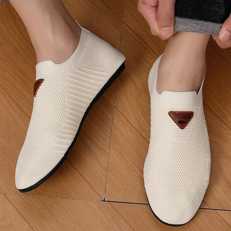 Men's walking sneakers: ultra-light AirKnit slip-ons for breathable comfort and casual style.