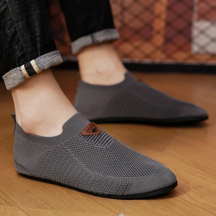 Comfortable men's slip-on sneakers featuring a breathable AirKnit upper and lightweight design.