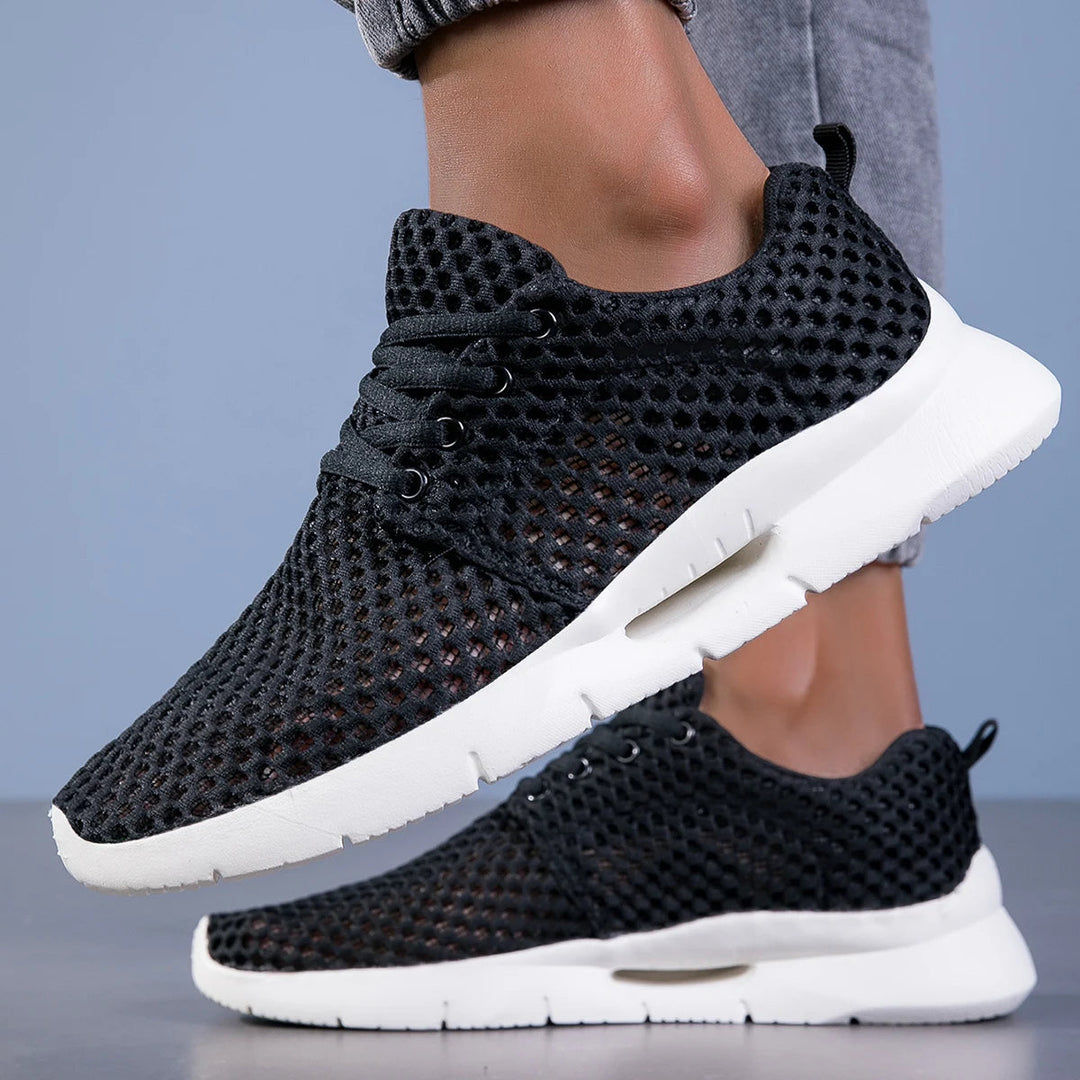 Sleek black men's ultra-light breathable sneakers, versatile for gym, running, and casual everyday wear.