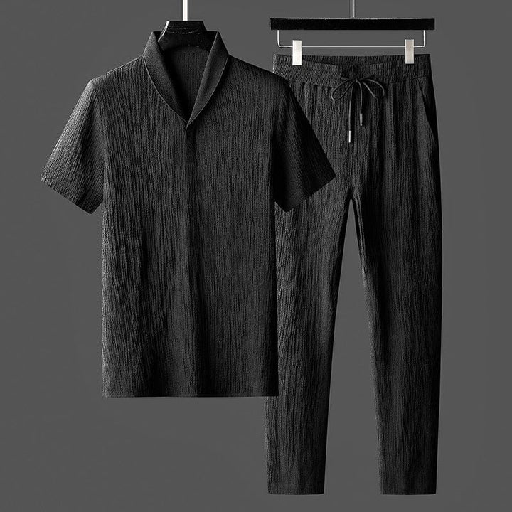 Versatile men's two-piece urban style outfit set. Comfortable top and trousers for modern casual wear.
