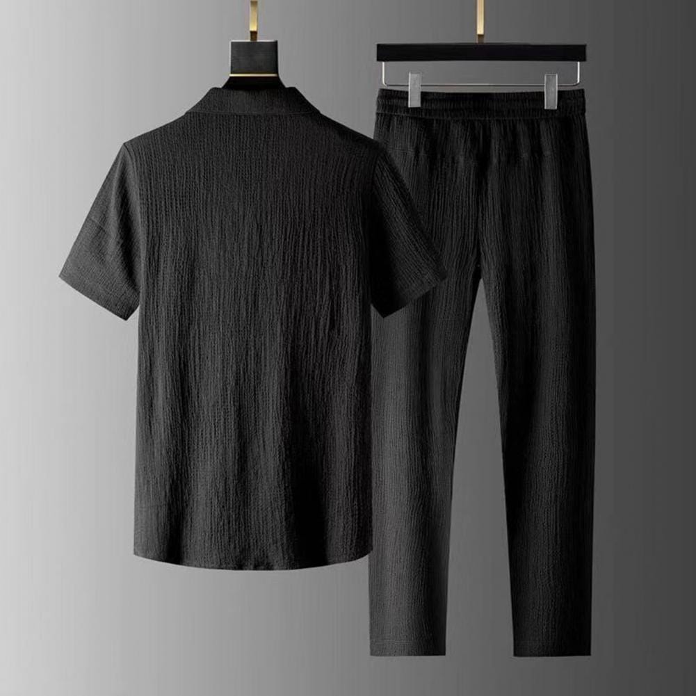 Man modeling a relaxed fit men's comfort lounge set. Urban top & trousers, perfect for stylish leisurewear.