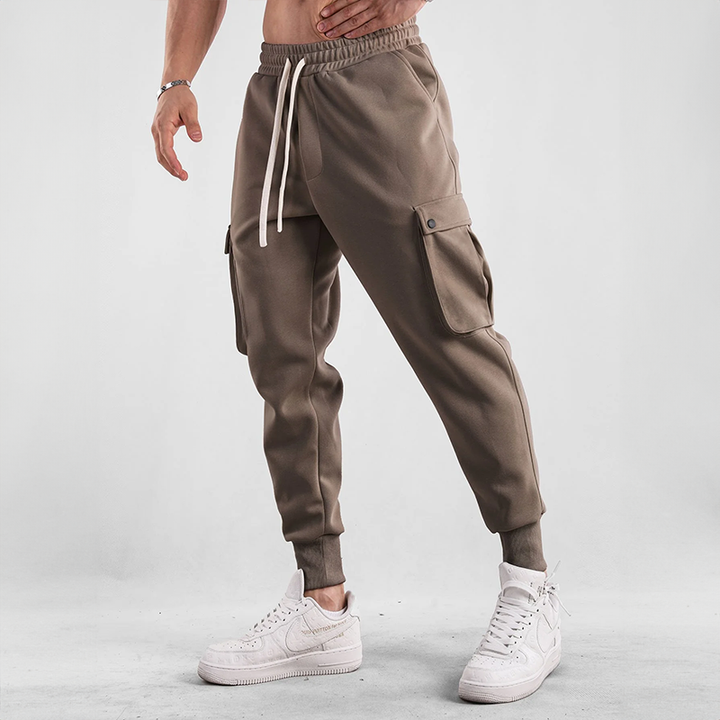 Modern men's urban joggers, designed with cargo pockets, stretch fabric for mobility, and comfort.