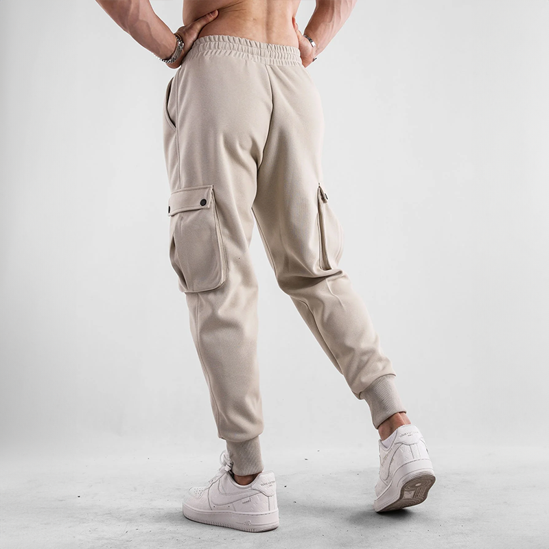 Athletic style men's cargo joggers, featuring stretch fabric and spacious pockets for active streetwear.