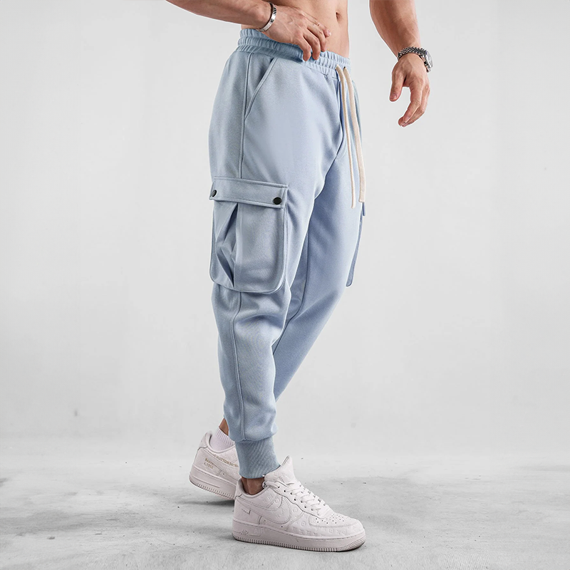 Flexible men's joggers for urban exploration, cargo pockets for essentials, comfort wear design.