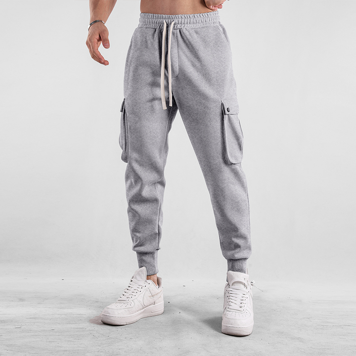 Detailed view of men's cargo jogger pocket, secure storage on soft, flexible stretch pants.