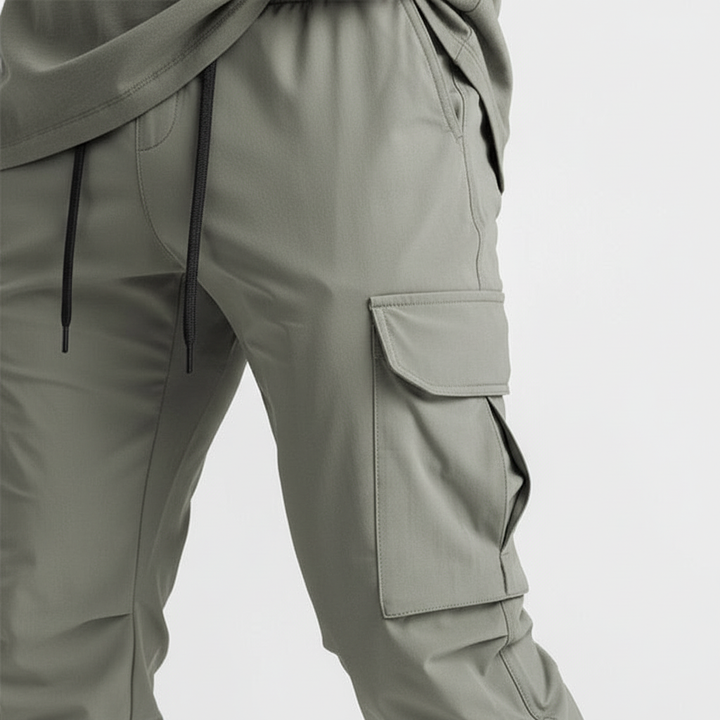 Men's athletic cargo joggers, stretch fabric for comfort, many pockets, performance ready.