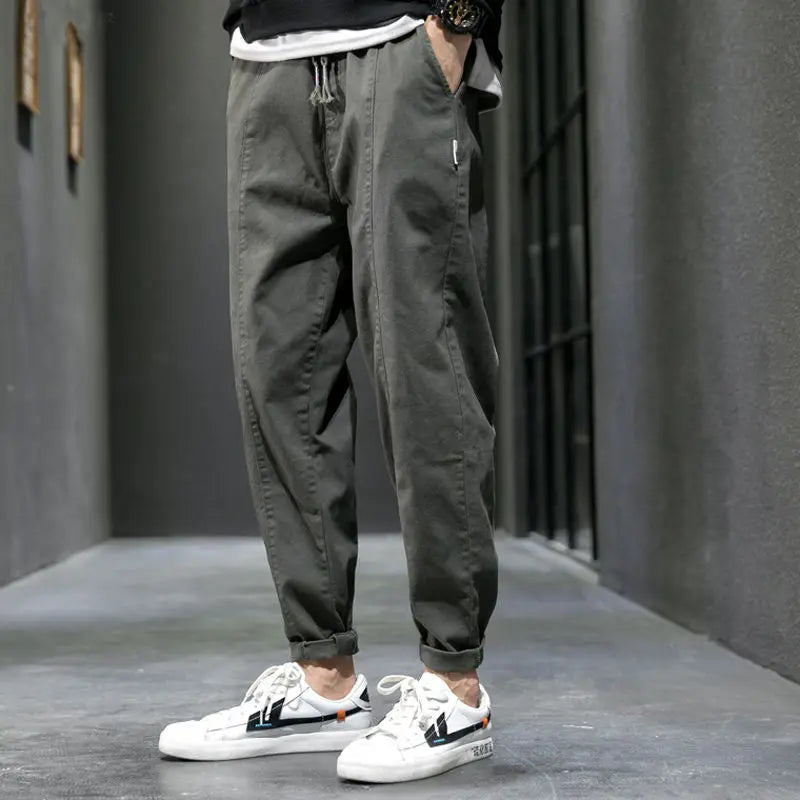 Black men's tapered joggers, ideal for urban style & athletic activities. Comfortable cotton blend pants.