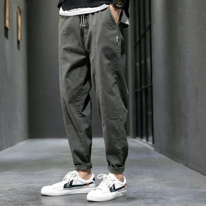 Black men's tapered joggers, ideal for urban style & athletic activities. Comfortable cotton blend pants.