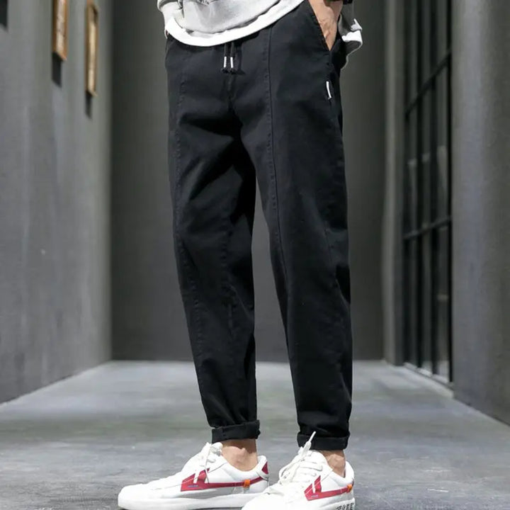 Army green men's tapered joggers, designed for urban comfort & athletic wear. Premium cotton blend.
