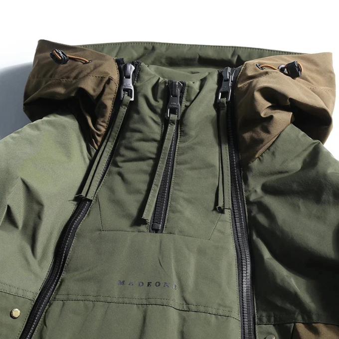 Model wearing a stylish green Men's Vector insulated techwear jacket, great for cold weather & utility.