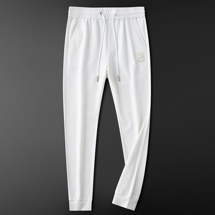 Man modeling Vellaros men's comfort joggers, highlighting their stylish tapered fit for streetwear.