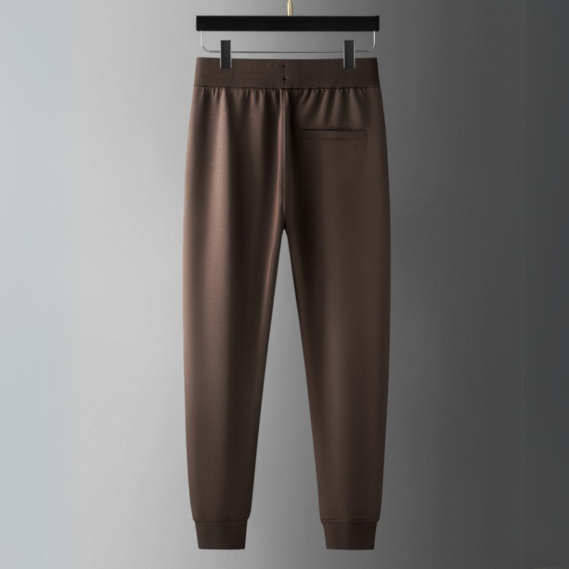 Man running in Verona Elite tracksuit set, showcasing athletic wear for peak performance & comfort.