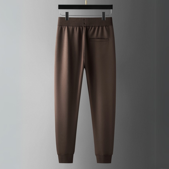 Man running in Verona Elite tracksuit set, showcasing athletic wear for peak performance & comfort.